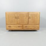 A mid-Century Ercol Windsor model 468 sideboard, in Golden Dawn with three cupboards and drawers