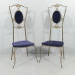 A pair of mid-century Italian Hollywood Regency brass chairs.