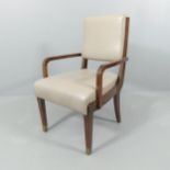 An Art Deco style leather upholstered desk armchair with brass feet.