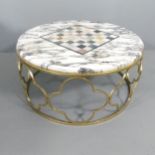 A contemporary circular marble games-top table on gilt-painted tubular metal frame. 90x44cm. Top has