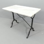 A rectangular marble top garden table on cast iron base. 100x76x60cm.