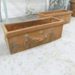 A pair of weathered terracotta rectangular garden planters with swag decoration. 59x21cm.