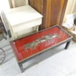 A mahogany and brass mounted coffee table with inset brass horse group under glass panel to top.