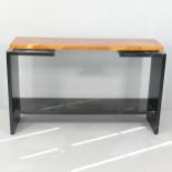A contemporary burr walnut veneered two-tier console table on black lacquered frame. 129x80x35cm.
