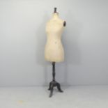 A Stockman's dressmaker's mannequin on ebonised stand. Height 157cm.