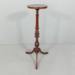 A reproduction mahogany torchere stand. with fluted column and tripod base. Height 96cm.