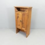 A modern stained pine two-door hall cabinet. 45x90x25cm.