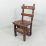 An antique mahogany metamorphic library chair with gothic style cut-outs. Chair: 45x90x43cm.