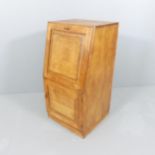 An Arts and Crafts Cotswold school design oak fall front cabinet with exposed dovetail