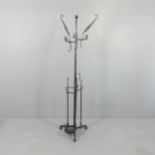 A contemporary brutalist wrought iron hat and coat stand with gloss burnt umber finish. Height