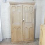 An antique pine larder cupboard, with two panelled doors revealing a shelved interior. 122x199x48cm.