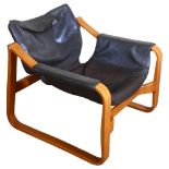 Maurice Prentice Burke, a rare leather lounge chair, the beech frame with sled base, with maker’s