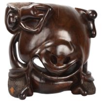 A large Makonde Shetani ironwood sculpture of unusual form of an abstract face with figures,