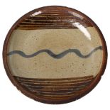 St Ives/Leach studio pottery, an early stoneware "Wave" plate, pottery mark to base, diameter 23cm A