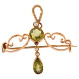 An Art Nouveau peridot and pearl openwork pendant/brooch, unmarked gold set with pear and round-
