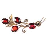 A mid-20th century garnet and pearl floral spray brooch, unmarked yellow metal settings 42mm, 4.1g