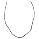 A modern 18ct white gold black diamond bead necklace, set with rough-cut black diamond beads, bead