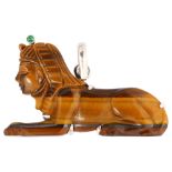 An 18ct white gold tigers eye and emerald Egyptian sphynx pendant, width 36.3mm, 6g No damage or