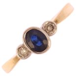 A modern 9ct gold three stone sapphire and diamond ring, bezel set with oval mixed-cut sapphire
