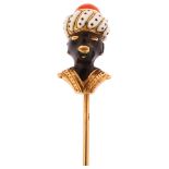 A 19th century coral and polychrome enamel Blackamoor stickpin, unmarked 14ct gold settings, head