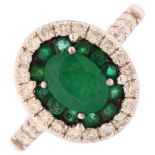 A modern 18th white gold emerald and diamond oval cluster ring, set with oval and round-cut emeralds