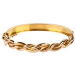 A Victorian 9ct rose gold woven hinged bangle, with engraved foliate decoration, band width 9.1mm,