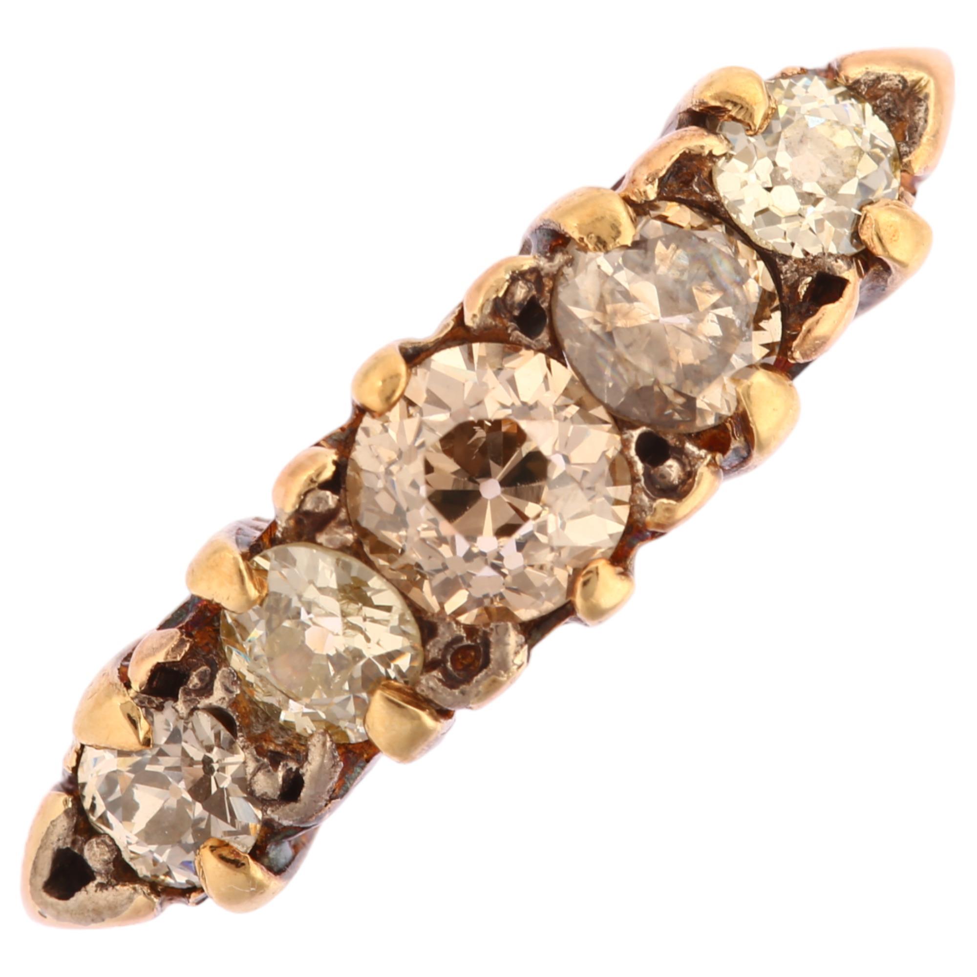 An early 20th century 18ct gold graduated five stone diamond half hoop ring, prong set with old
