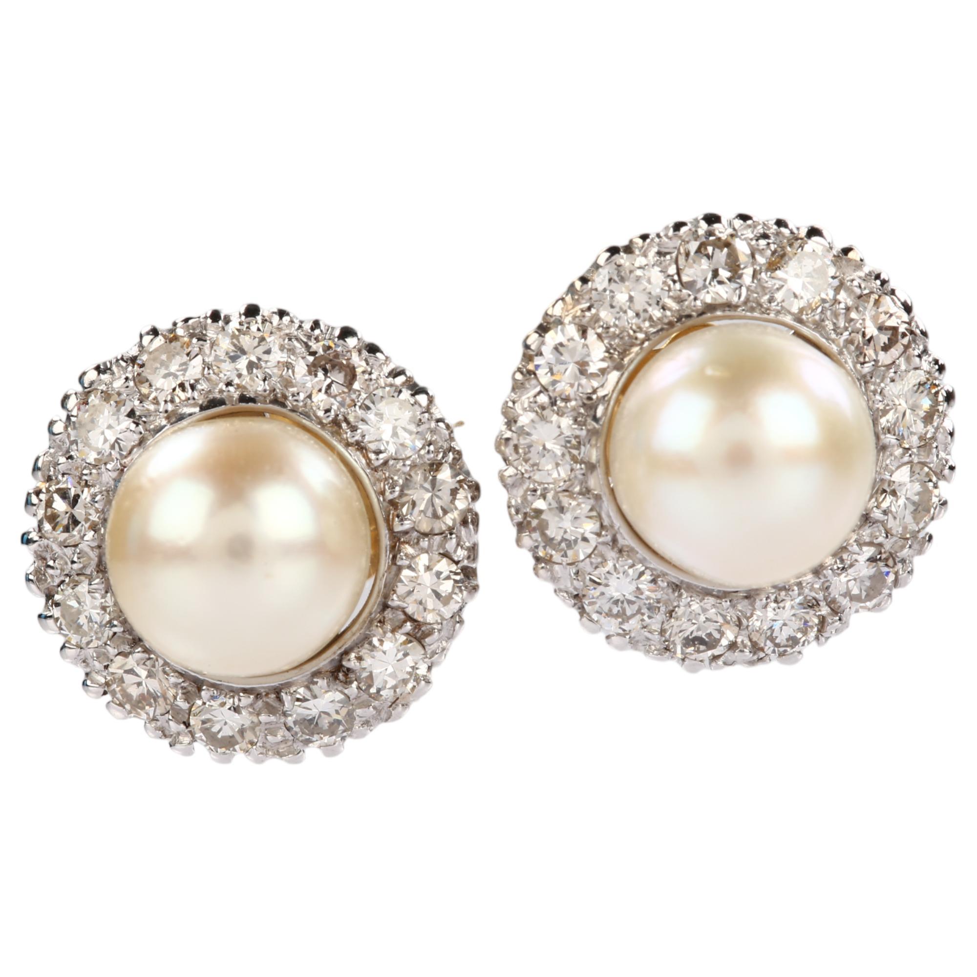A pair of whole pearl and diamond round cluster earrings, unmarked white gold settings test as 18ct,