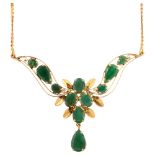 A Middle Eastern emerald floral collar necklace, unmarked high carat gold settings with oval and