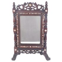 A Chinese padouk wood dressing table mirror, with carved and pierced frieze, and floral mother-of-