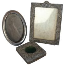 An oval silver-fronted photo frame and strut, an embossed silver-fronted rectangular frame, and an