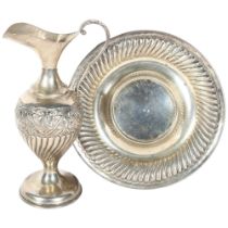 A Continental silver ewer on fitted circular stand (2 pieces), with embossed and fluted