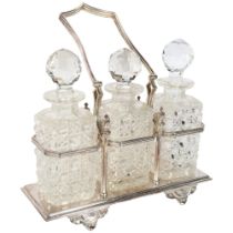 A silver plate on copper 3-section decanter stand with swing handle, together with a set of 3