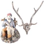 A Capodimonte figure with sheep, 29cm, and a pair of wall-mounted polished metal antlers
