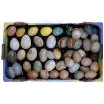 A tray of various turned stone eggs, assorted sizes