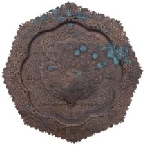 An embossed and pierced Eastern copper tray, depicting a peacock, 54cm
