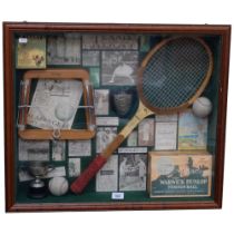 A framed montage of tennis related items, including tennis ball box, photographic prints, trophy