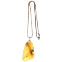 A Baltic amber silver-mounted pendant and chain