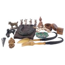 A tray of interesting items, including a pair of antler mounted salad servers, a ceramic cat music