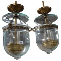 A pair of glass bell jar shaped globe lanterns, with cast-brass components, including peacock