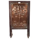 A Victorian Art Nouveau fire screen, with stylised repousse copper panel, oak-framed, H69cm