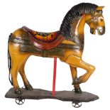 A late 19th/early 20th century German hand-painted child's play-horse on wheeled stand, H77cm