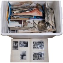 A boxful of loose postcards and photographs, and an album