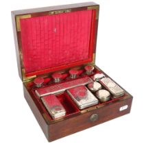 A 19th century mahogany and brass-bound vanity case, partly fitted with bottles and boxes with