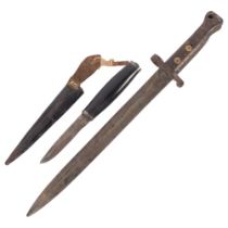 A First World War Period bayonet, with impressed marks, L42cm, and a small ebony barrel handled