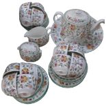 A Minton Haddon Hall tea service, comprising teapot, large plate, 12 cups, 12 saucers, 8 tea plates,