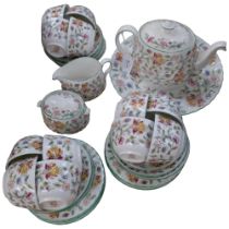 A Minton Haddon Hall tea service, comprising teapot, large plate, 12 cups, 12 saucers, 8 tea plates,