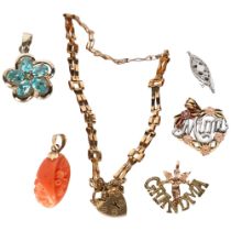 A group of 9ct gold jewellery, including a small open link bracelet, a coral pendant, and 3 other