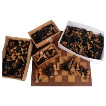 A large quantity of loose and unassociated turned wood chess pieces, and a hardwood chessboard