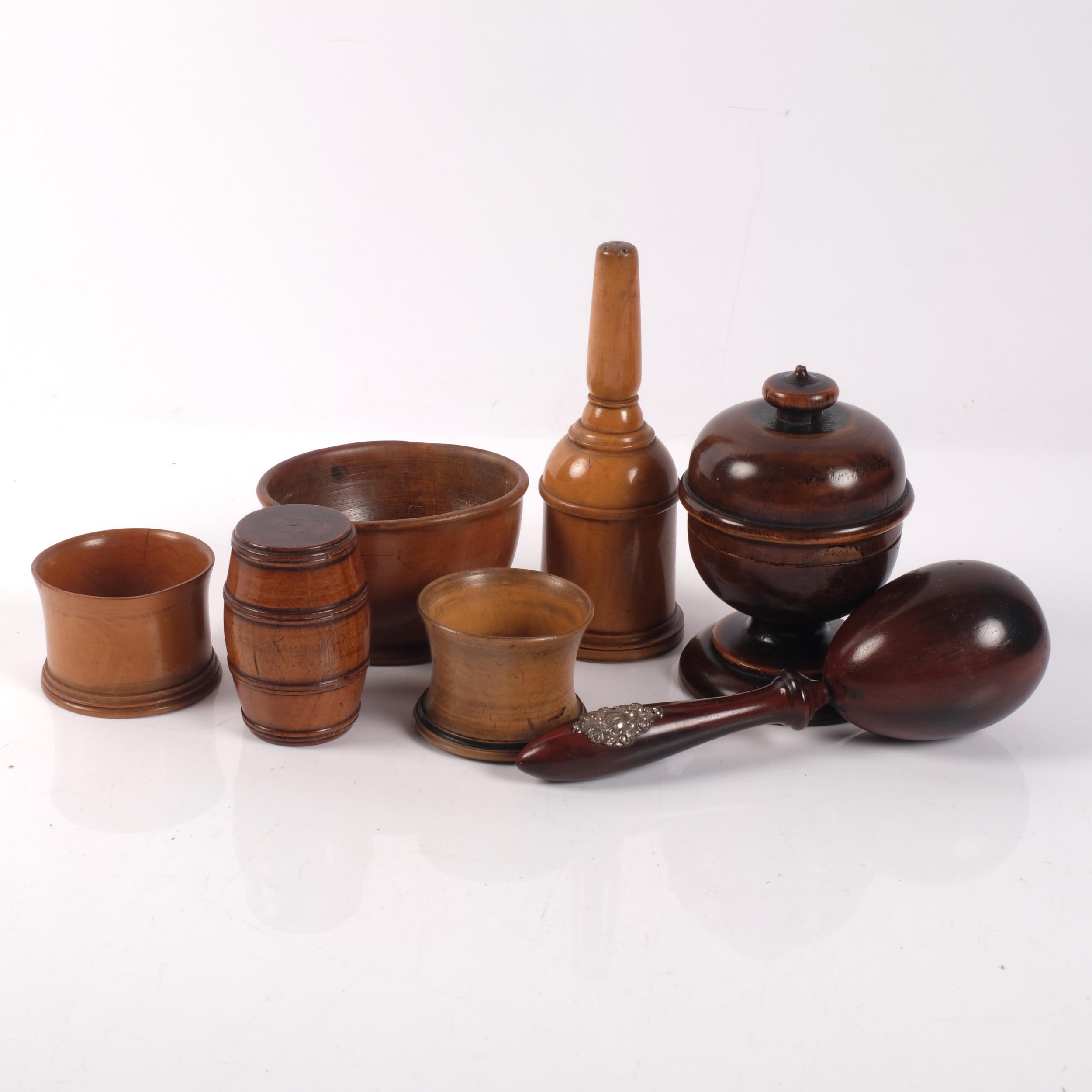 A group of Antique treen items, including a string box, a silver-mounted pestle, a wig powderer
